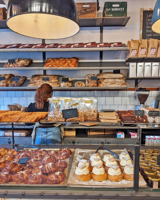 The display cases of bread, semlor and buns at Fabrique bakery.