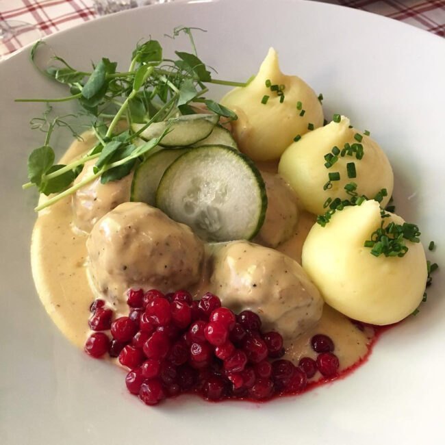 Meatballs and mash at Under Kastanjen. Lingon and cucumbers are served alongside.
